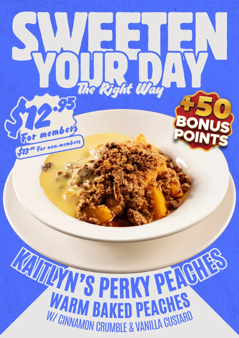 Warm baked peaches September dessert special with a cinnamon crumble and vanilla custard